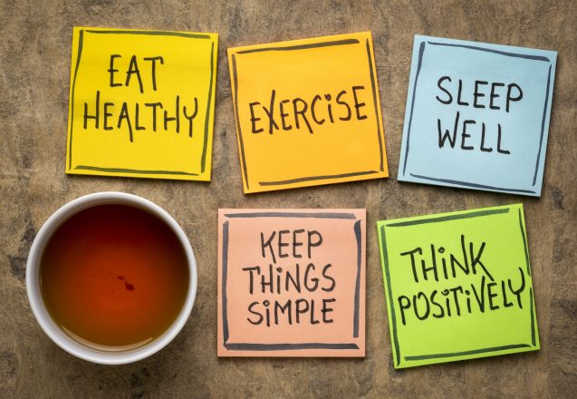 healthy lifestyle and wellbeing concept - a set of inspirational reminder notes with a cup of tea: eat healthy, exercise, seep well, keep things simple, think positively