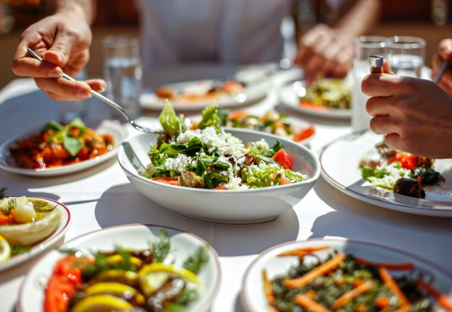 Couple  Eating Lunch with Fresh Salad and Appetizers